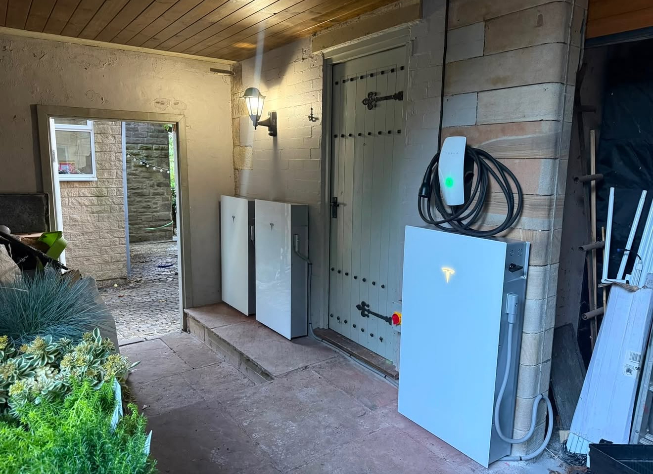 Tesla charging system installed with battery storage at a residential property