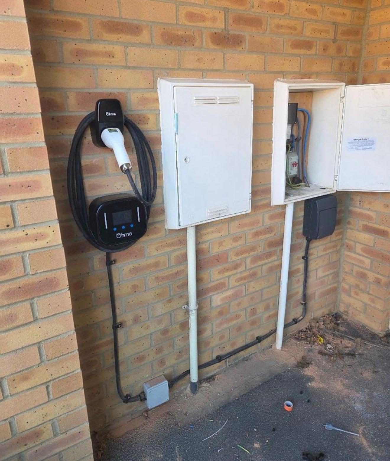 Ohme EV charger installed beside the property's electrical equipment